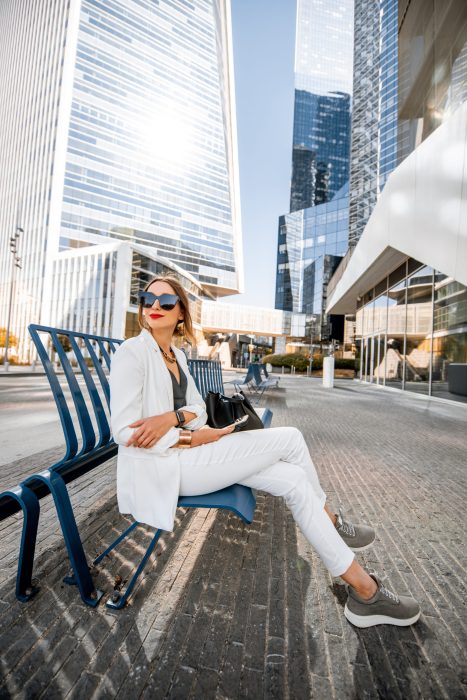 Business woman sitting outdoors at the financial district